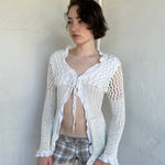 Woman Dressed in Y2K White crochet tie front cardigan featuring a layered bust design
