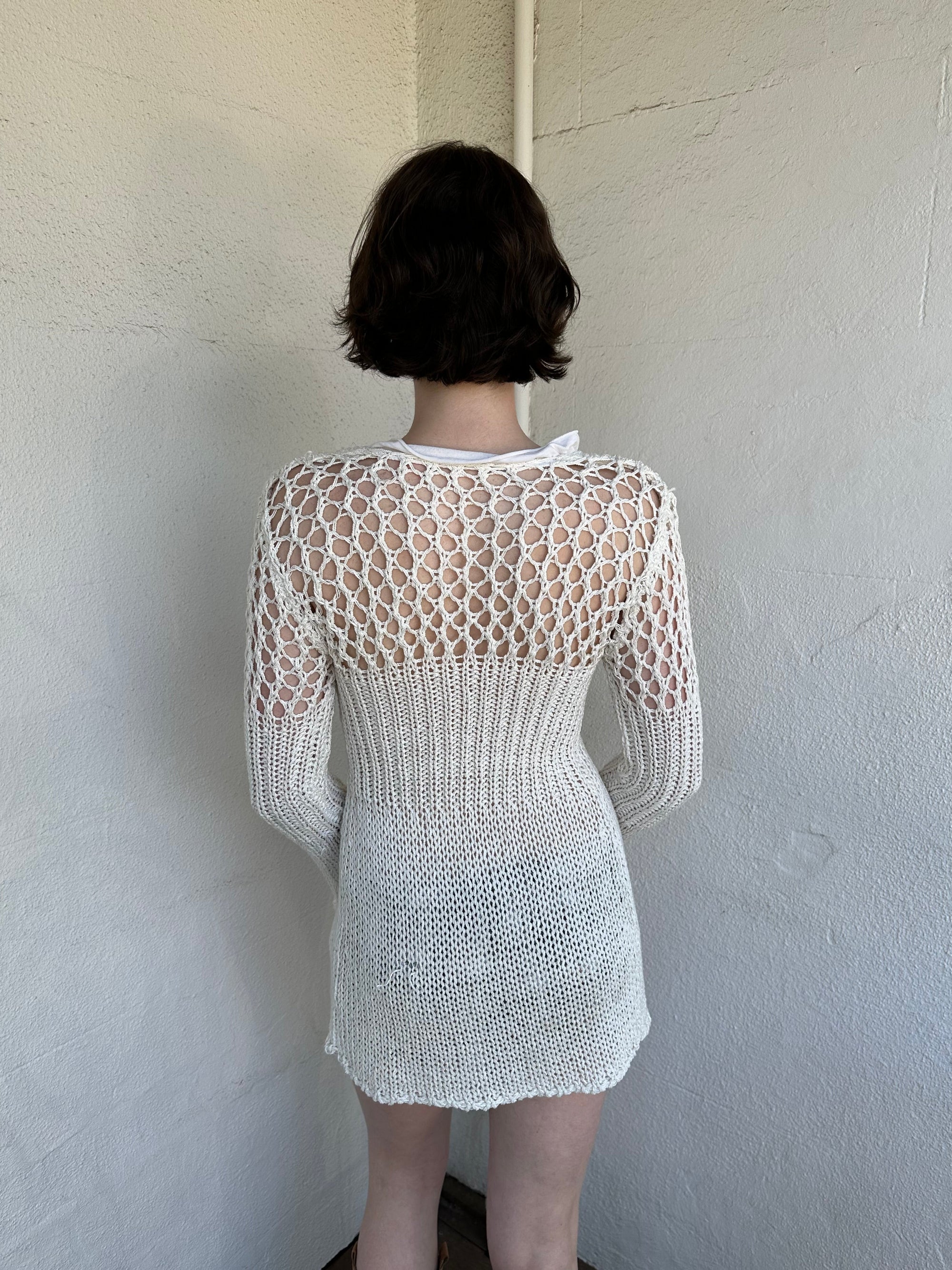 Woman Dressed in Y2K White crochet tie front cardigan featuring a layered bust design