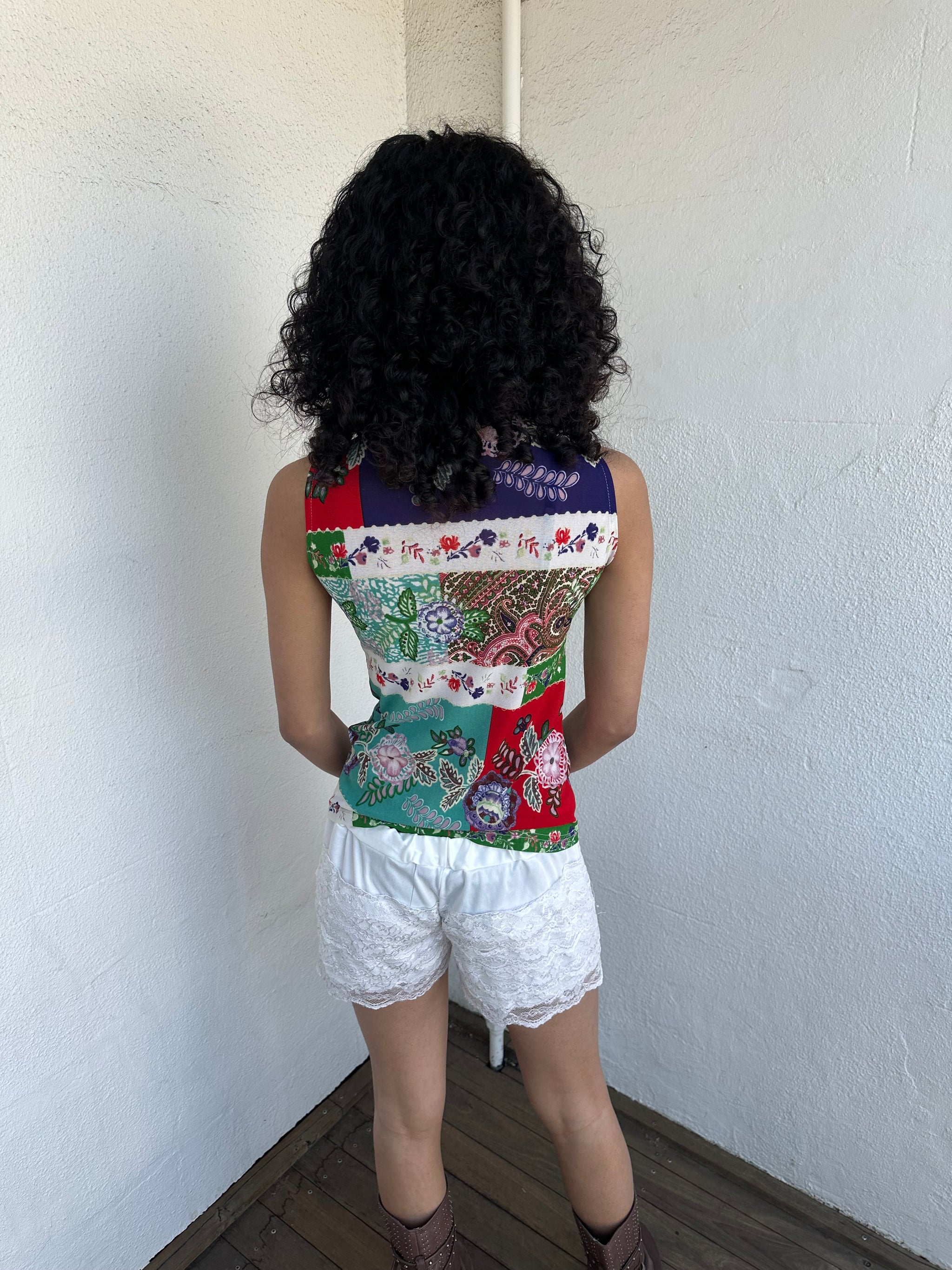 Woman wearing a Y2K 00s White lace bloomer shorts a festival classic. Delicate layered lace detailing with bow detail. 