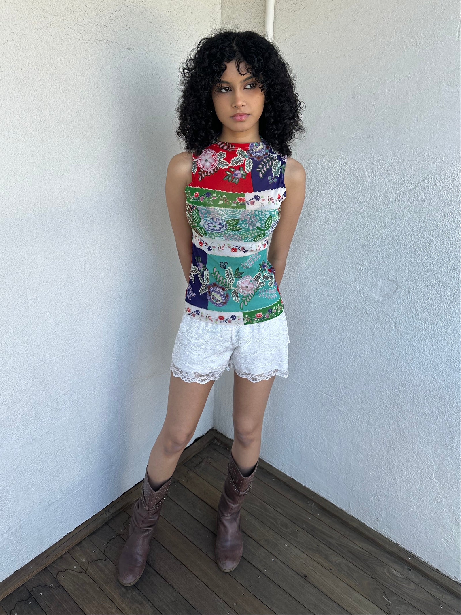 Woman wearing a Y2K 00s White lace bloomer shorts a festival classic. Delicate layered lace detailing with bow detail. 