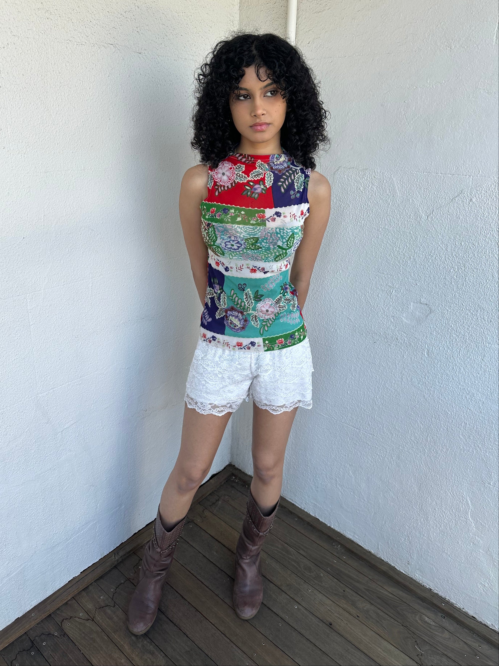 Woman wearing a Y2K 00s White lace bloomer shorts a festival classic. Delicate layered lace detailing with bow detail. 