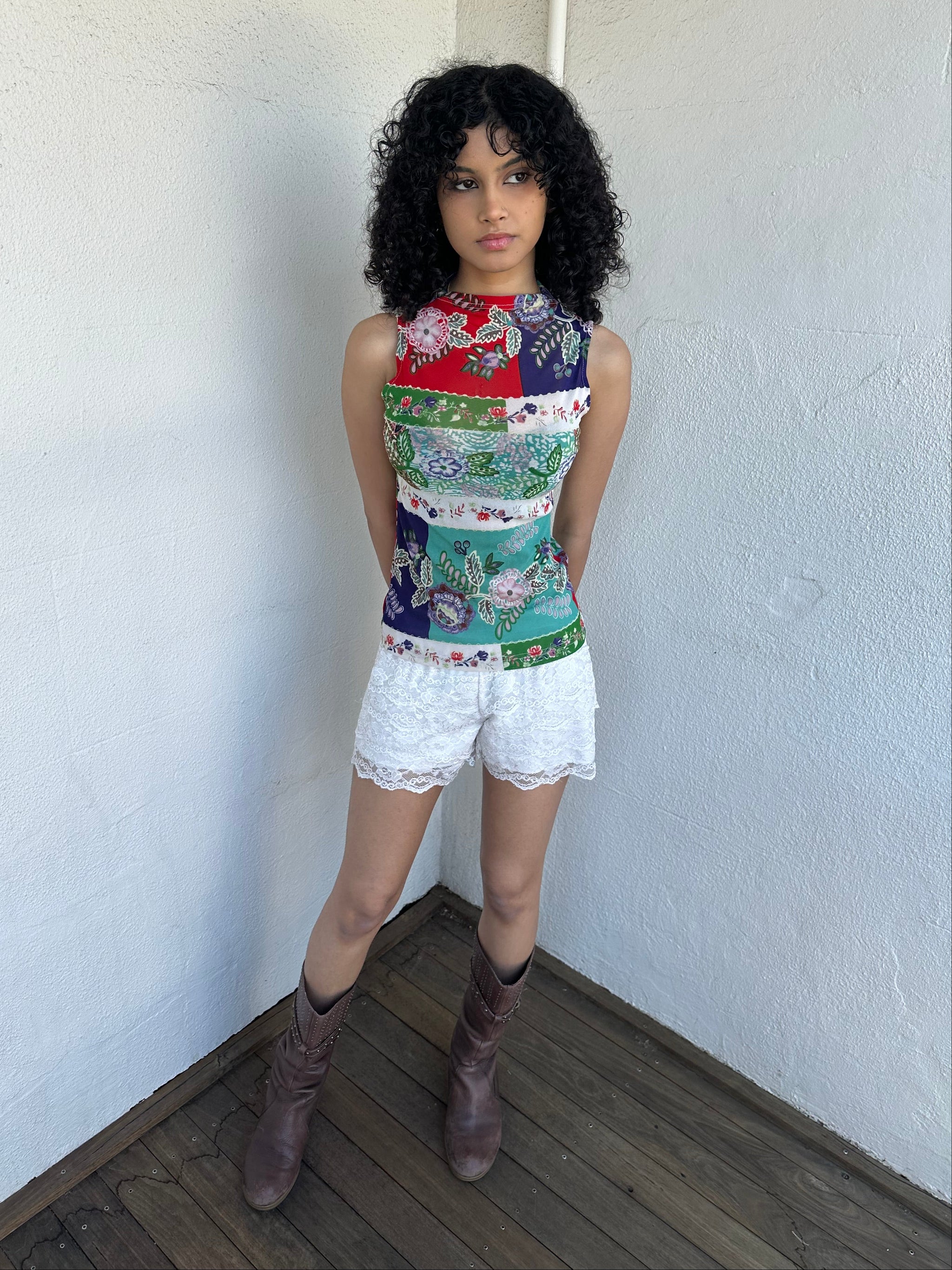 Woman wearing a Y2K 00s White lace bloomer shorts a festival classic. Delicate layered lace detailing with bow detail. 