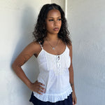 Woman Dressed in Y2K 00s White light cotton cami with a soft, breathable feel and relaxed silhouette. 
