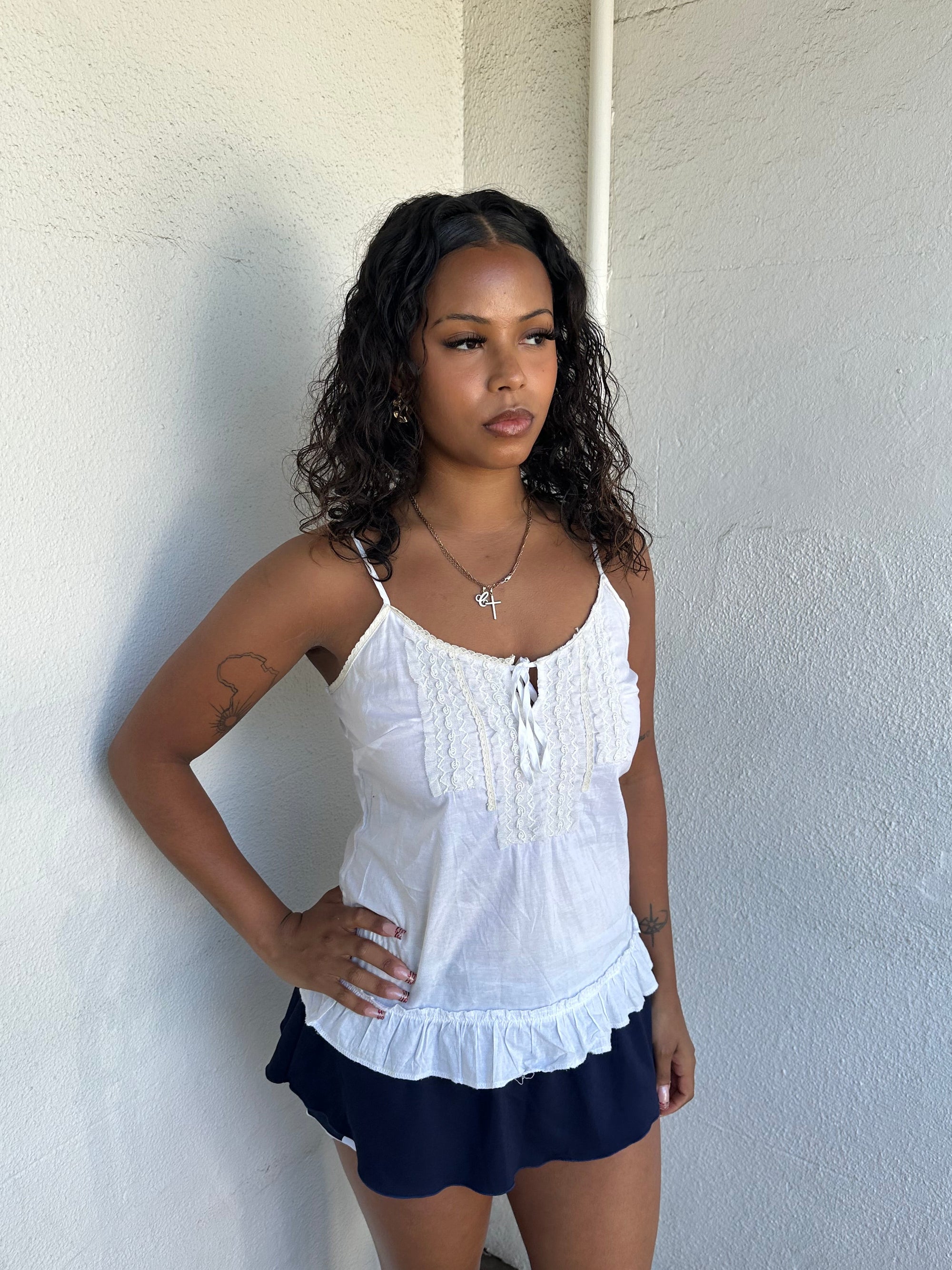 Woman Dressed in Y2K 00s White light cotton cami with a soft, breathable feel and relaxed silhouette. 