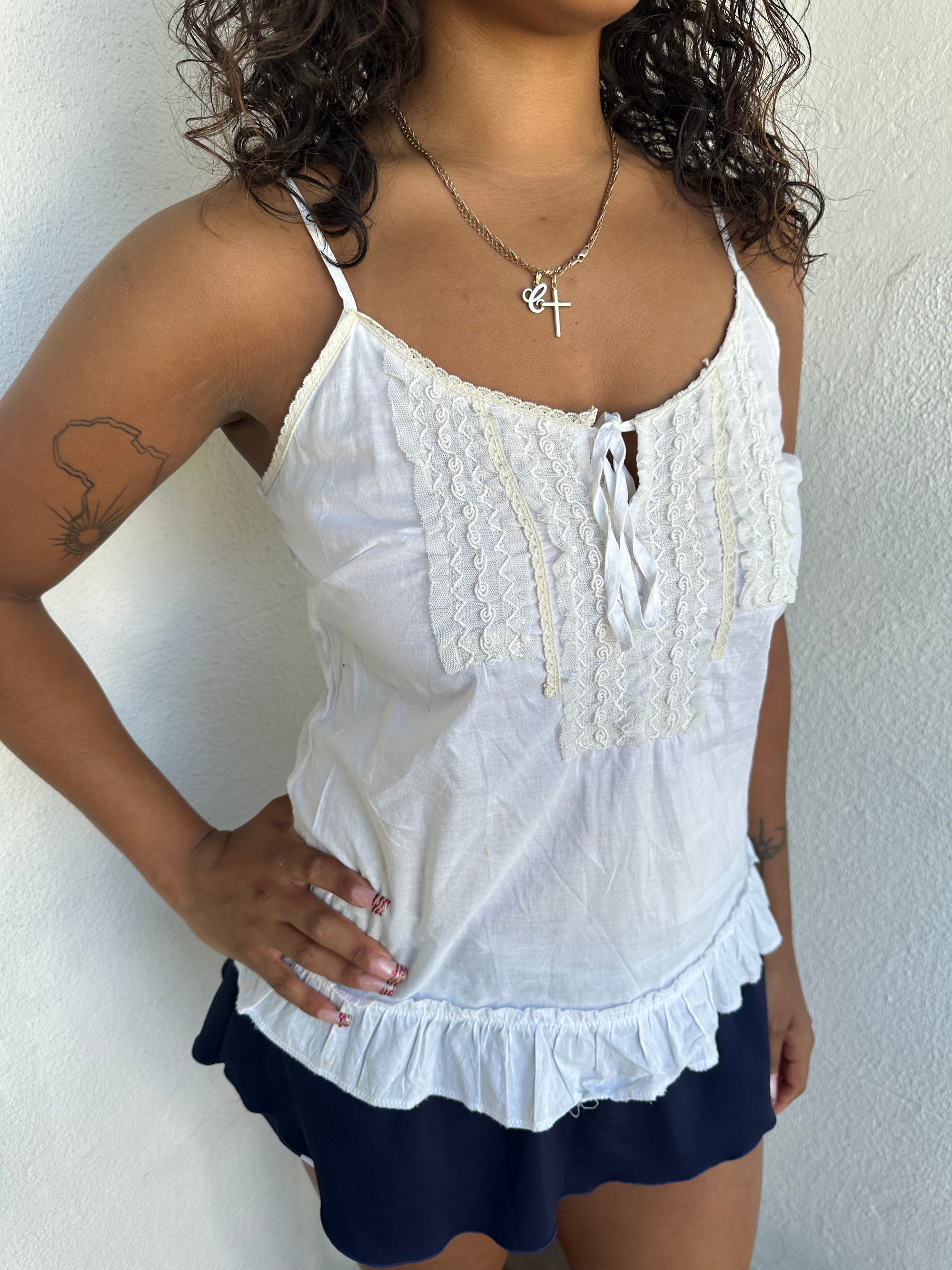 Woman Dressed in Y2K 00s White light cotton cami with a soft, breathable feel and relaxed silhouette. 