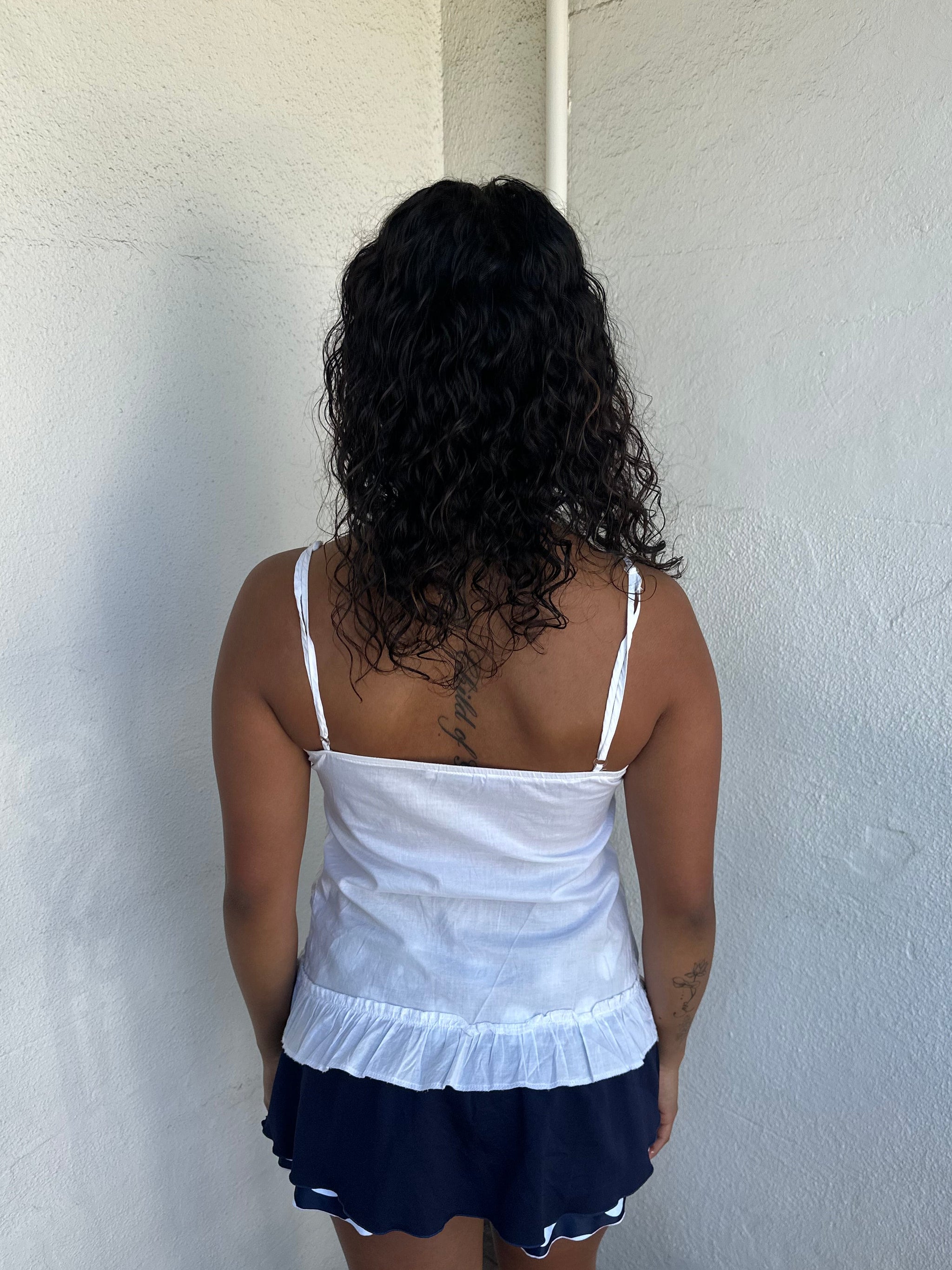 Woman Dressed in Y2K 00s White light cotton cami with a soft, breathable feel and relaxed silhouette. 