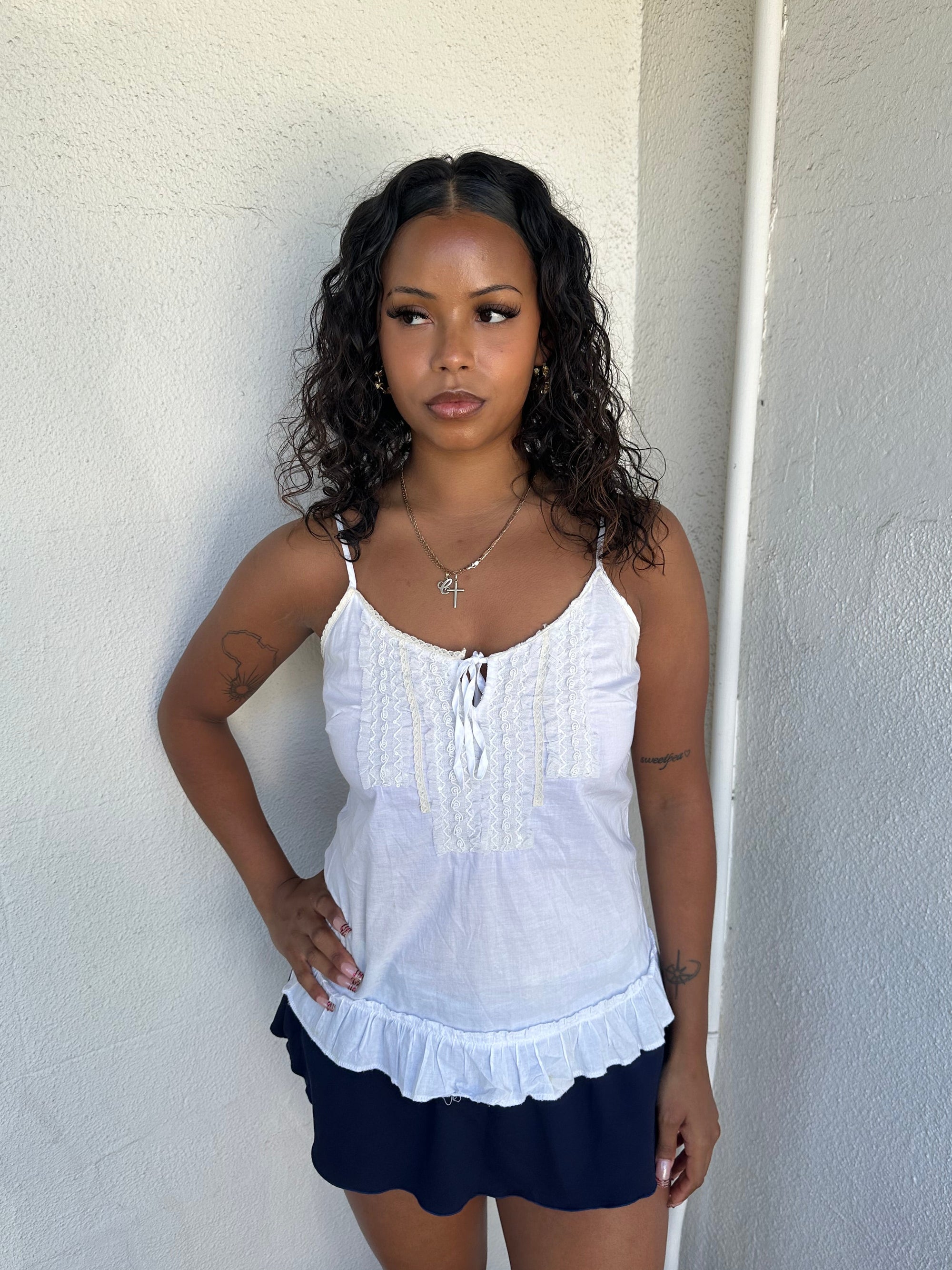 Woman Dressed in Y2K 00s White light cotton cami with a soft, breathable feel and relaxed silhouette. 