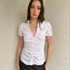 Women wearing a 00s Y2K White ruched textured shirt featuring gathered detailing through the body for a fitted look.