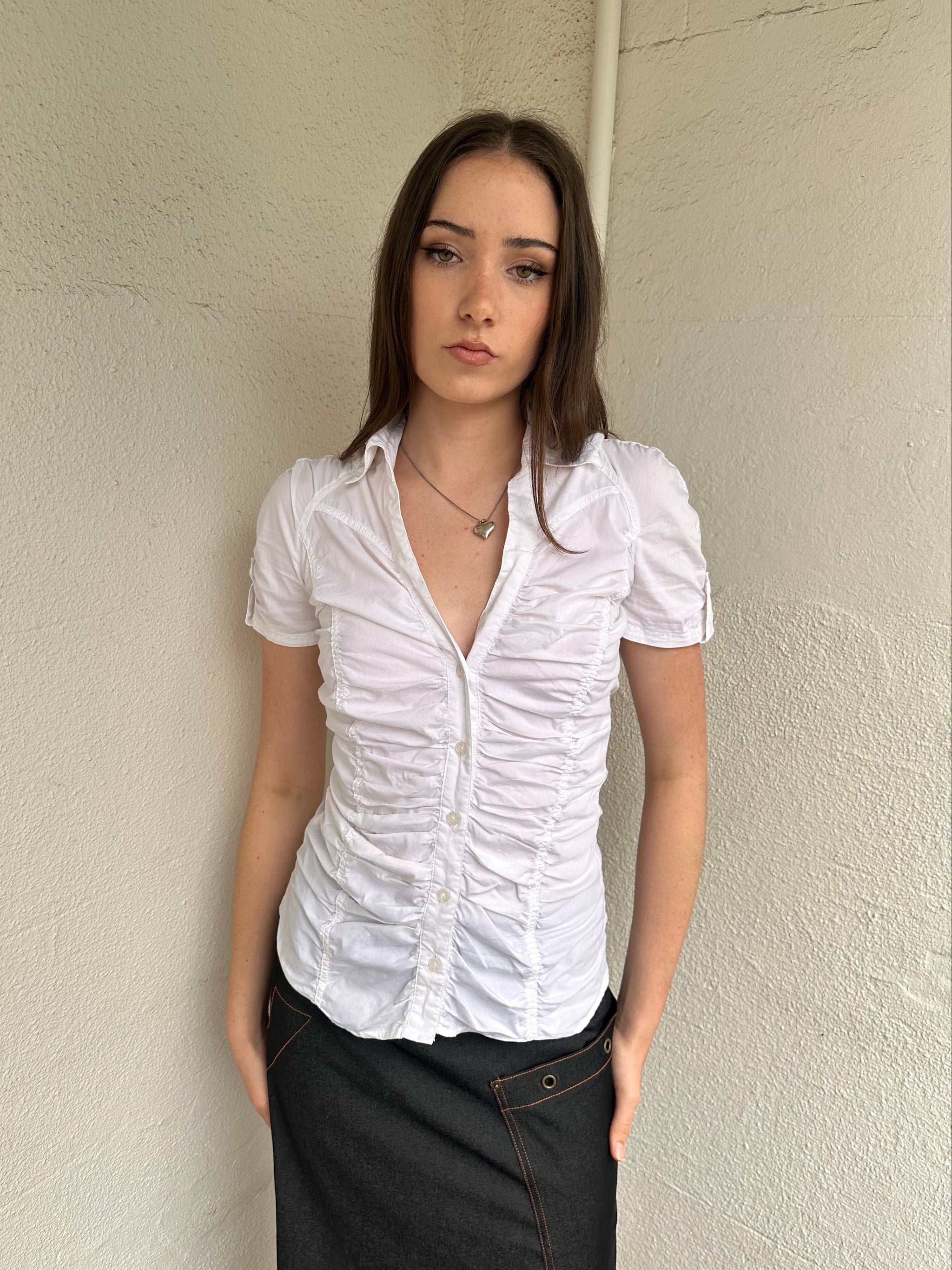 Women wearing a 00s Y2K White ruched textured shirt featuring gathered detailing through the body for a fitted look.