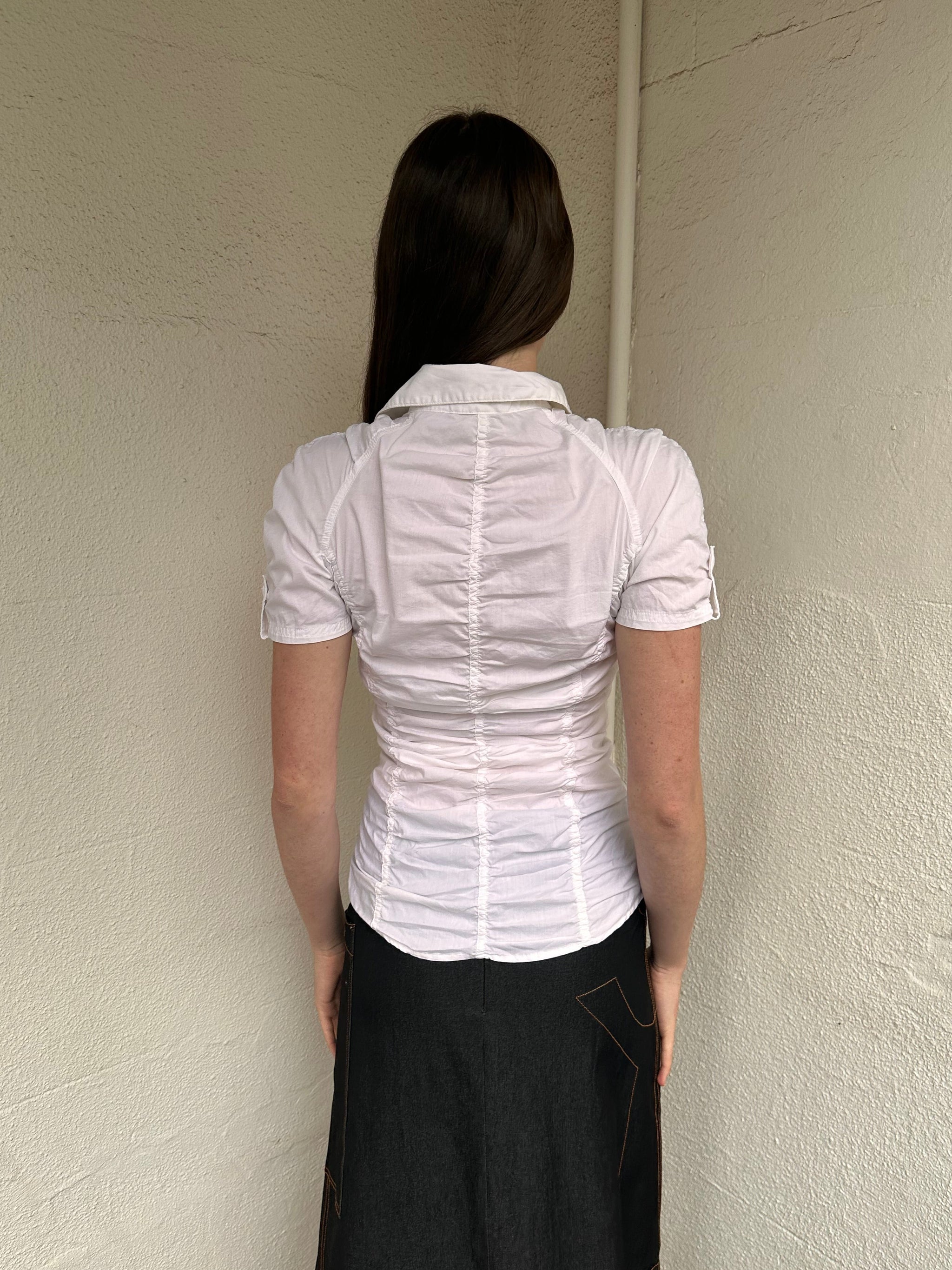 Women wearing a 00s Y2K White ruched textured shirt featuring gathered detailing through the body for a fitted look. 