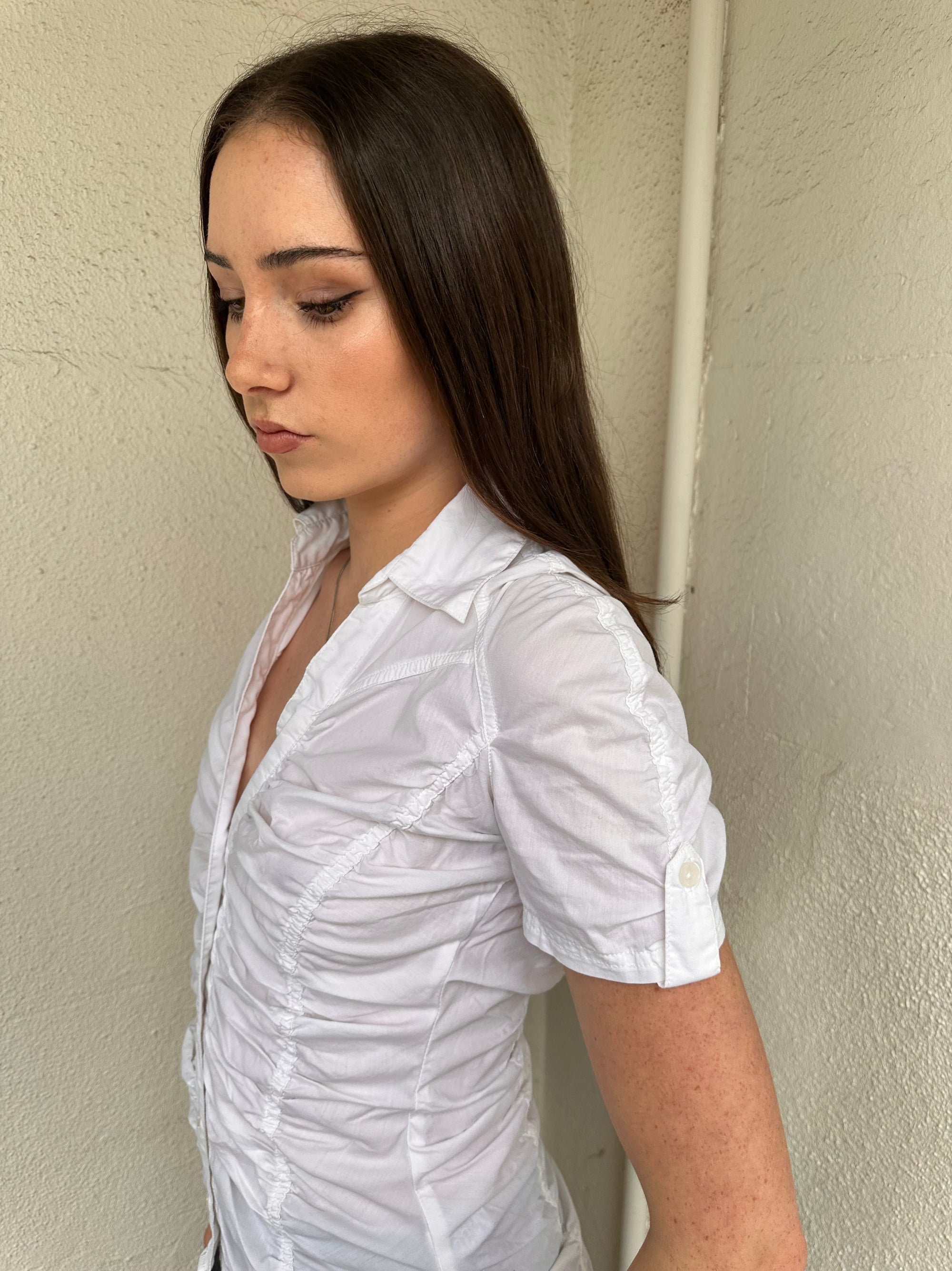 Women wearing a 00s Y2K White ruched textured shirt featuring gathered detailing through the body for a fitted look. 