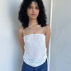 Woman wearing a Y2K 00s white mesh side drawstring strapless top
