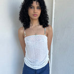 Woman wearing a Y2K 00s white mesh side drawstring strapless top
