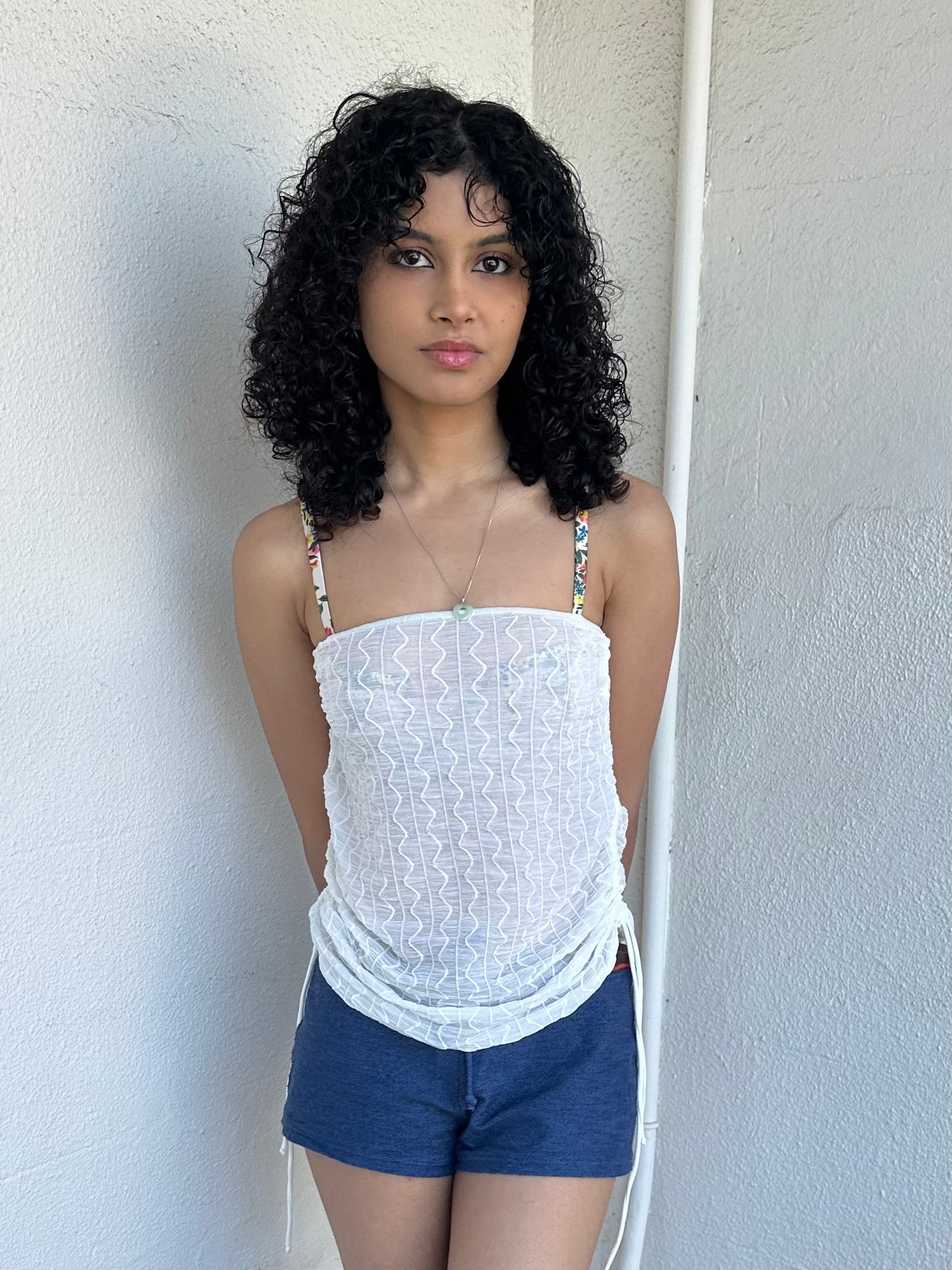 Woman wearing a Y2K 00s white mesh side drawstring strapless top
