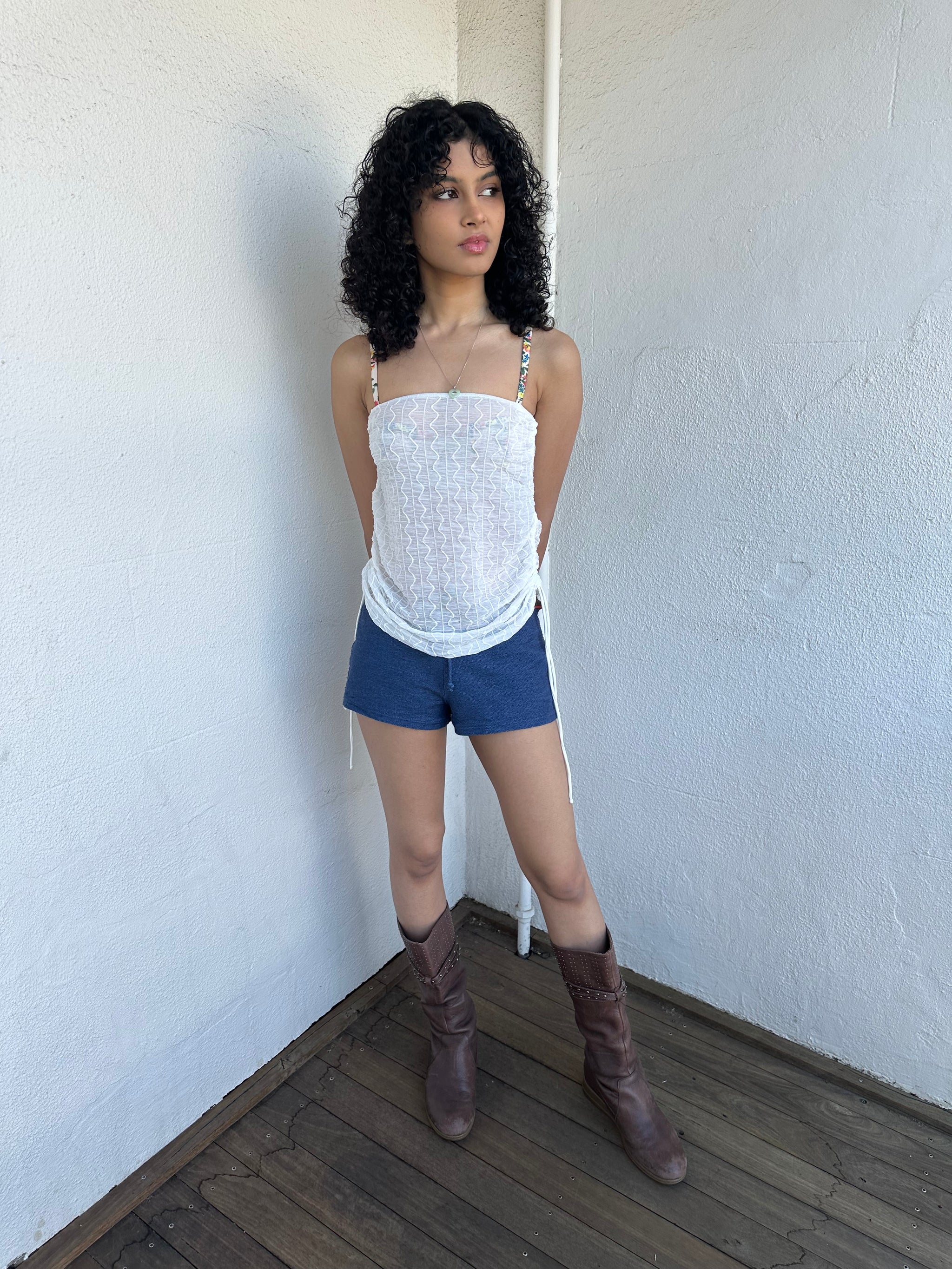 Woman wearing a Y2K 00s white mesh side drawstring strapless top