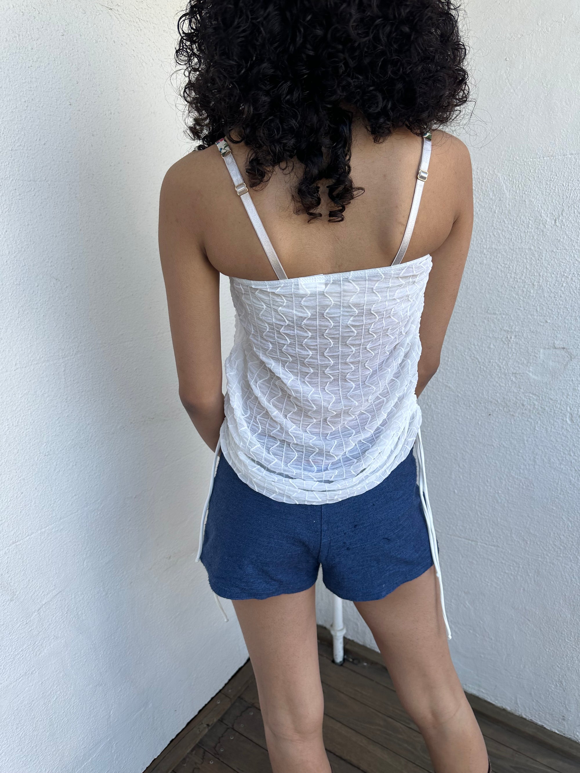 Woman wearing a Y2K 00s white mesh side drawstring strapless top