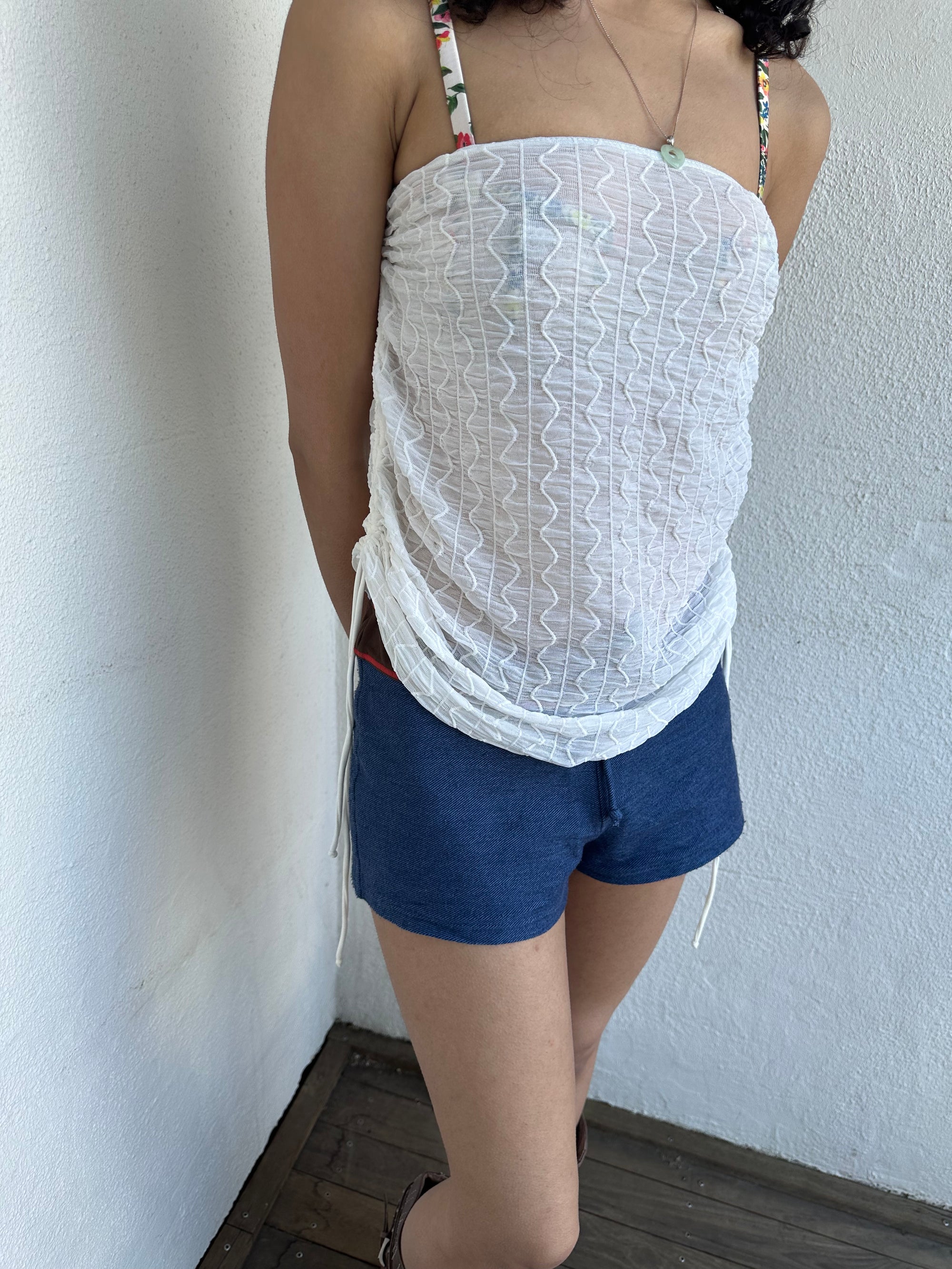 Woman wearing a Y2K 00s white mesh side drawstring strapless top