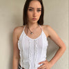 Woman wearing a Y2K 00s white ruffle front halter top 