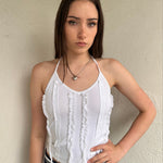 Woman wearing a Y2K 00s white ruffle front halter top 