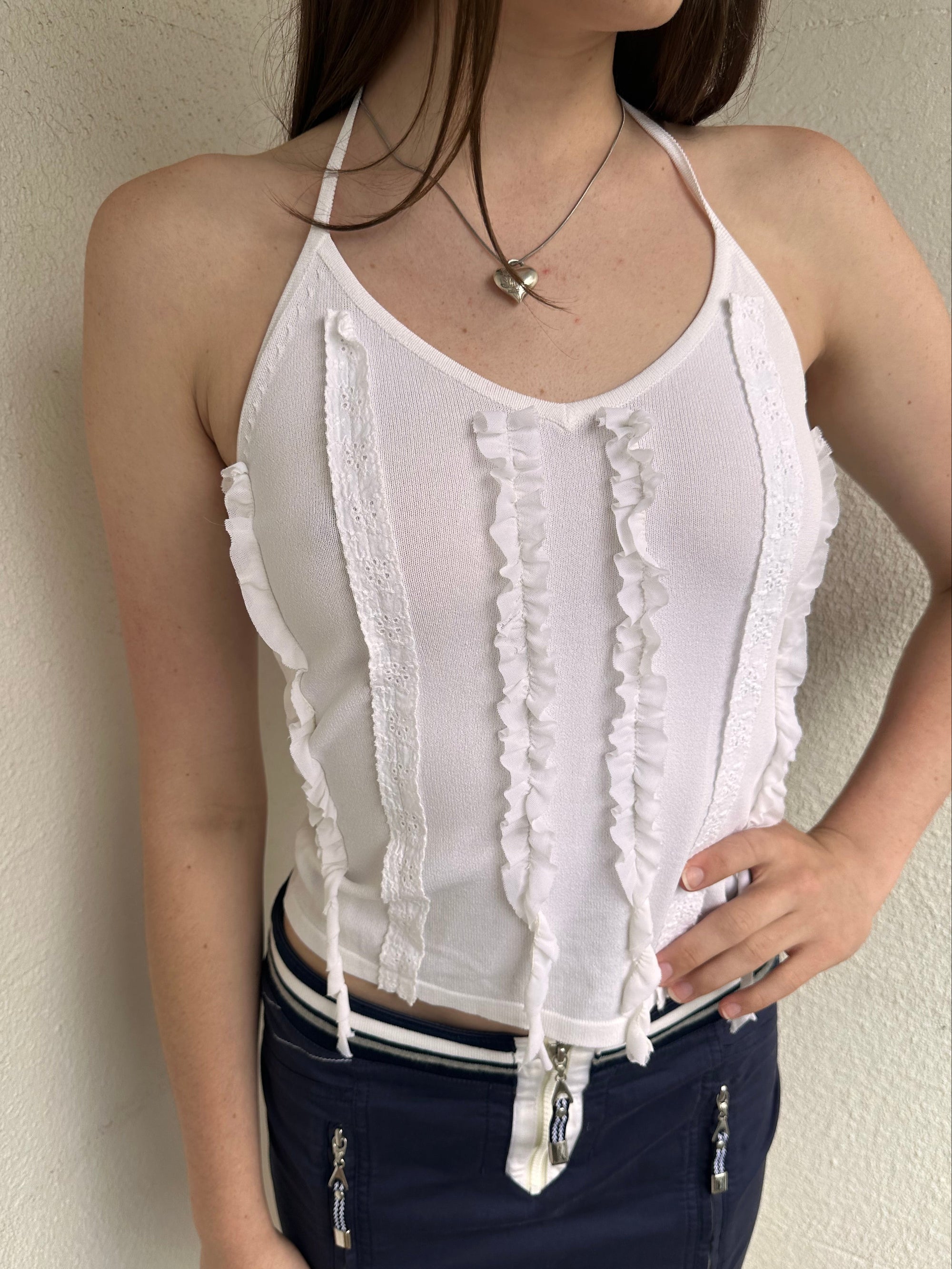 Woman wearing a Y2K 00s white ruffle front halter top 