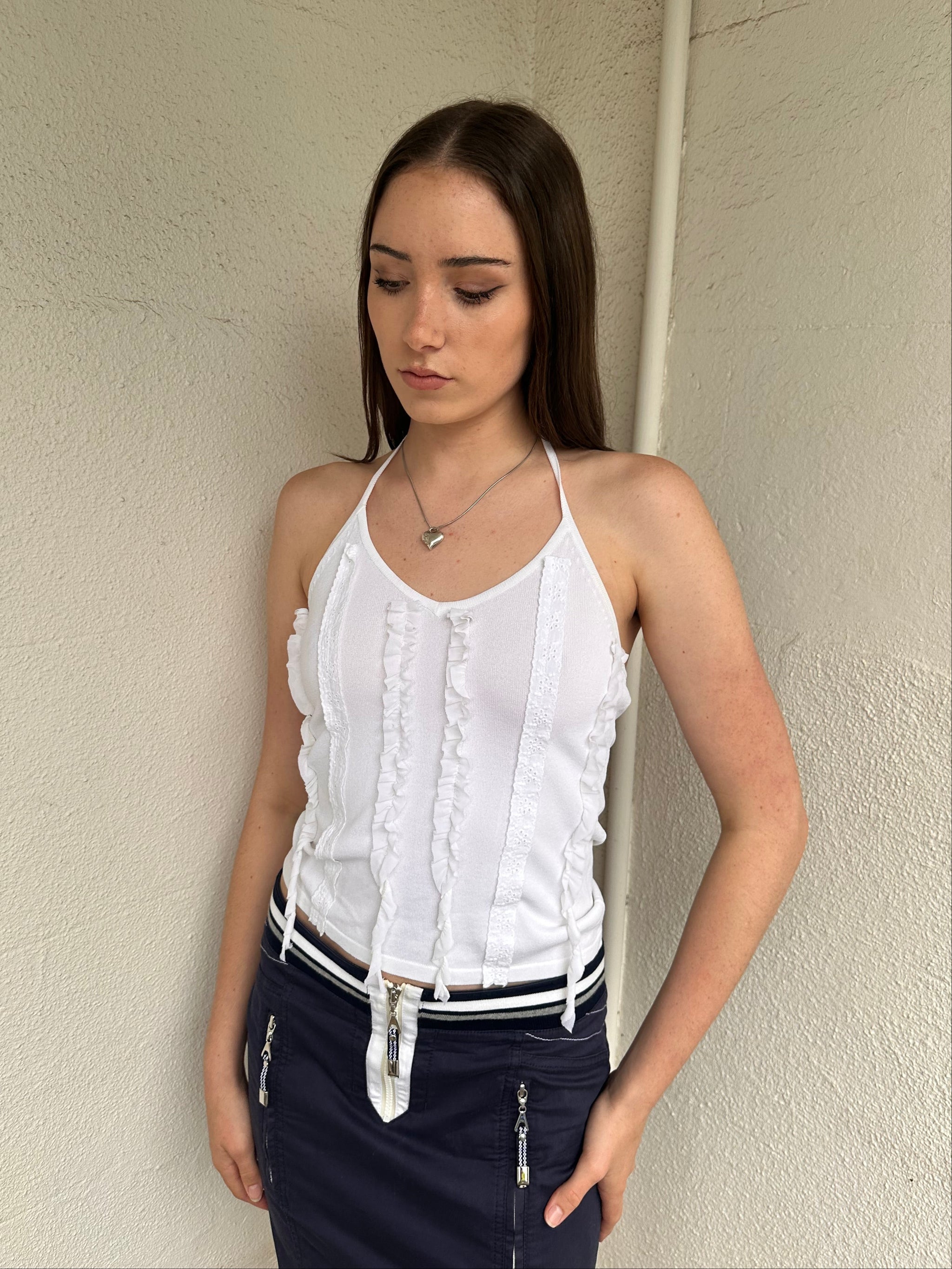 Woman wearing a Y2K 00s white ruffle front halter top 