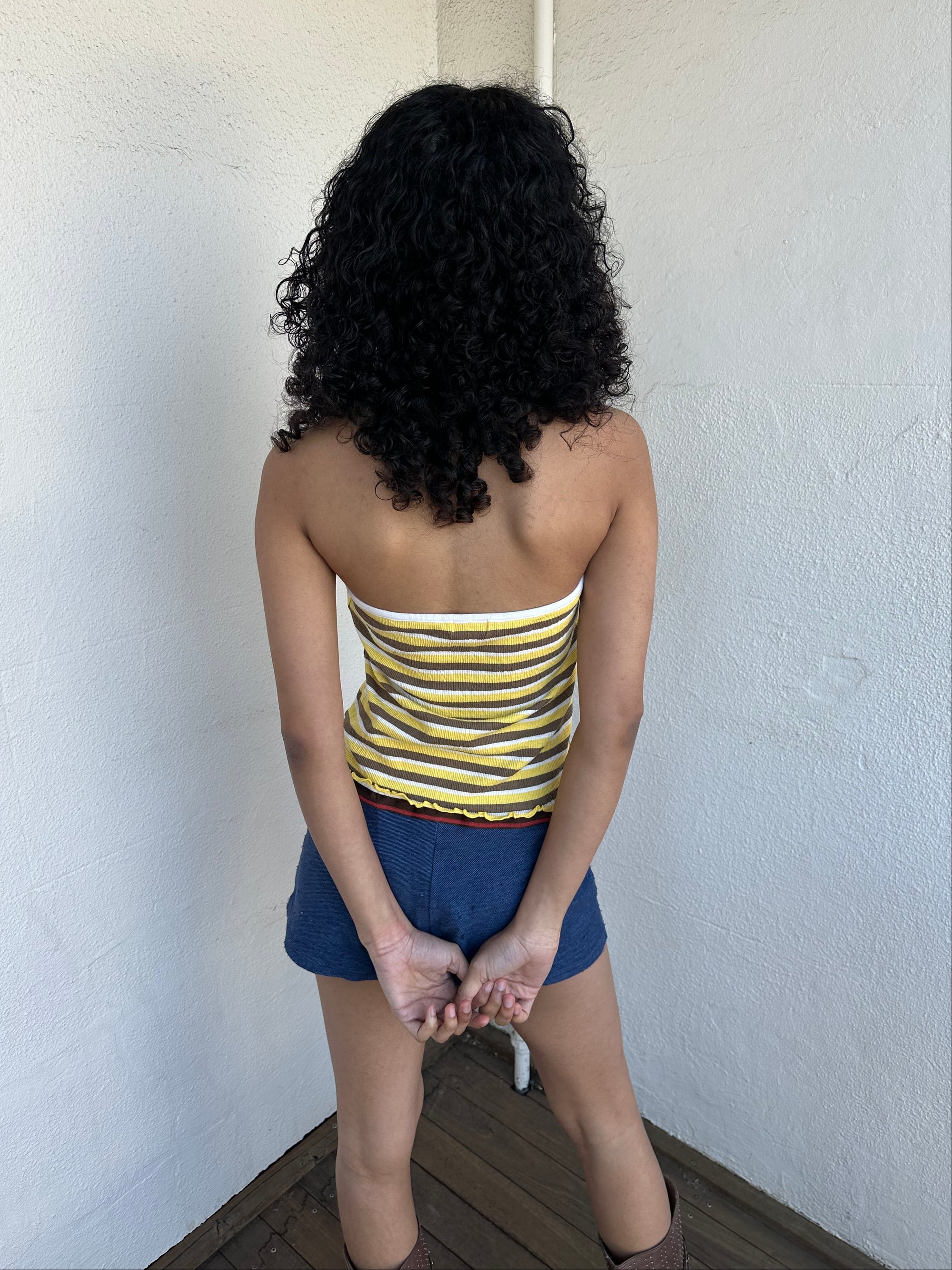 Women wearing a 00s Y2K Elle yellow, white and brown stripe halter top featuring a flower rosette detail on the front.
