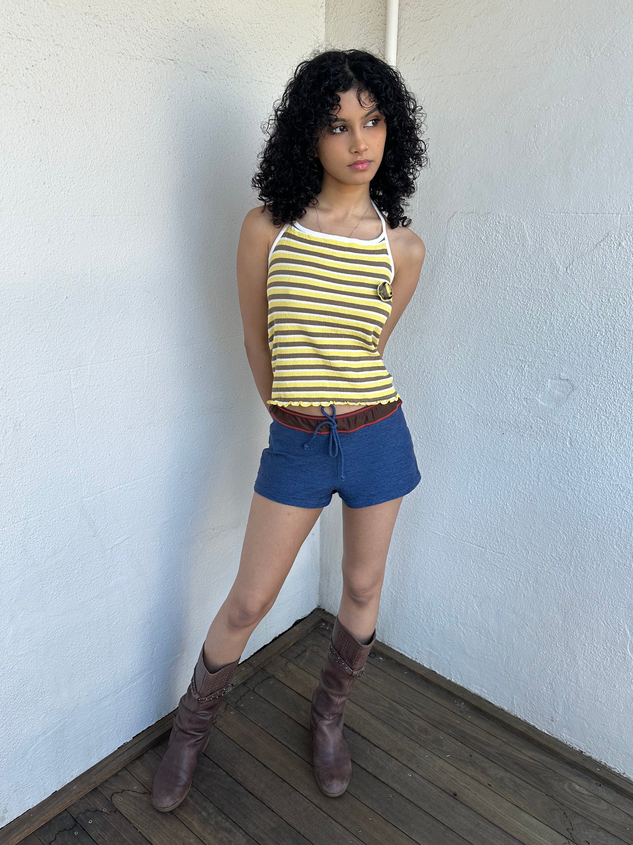 Women wearing a 00s Y2K Elle yellow, white and brown stripe halter top featuring a flower rosette detail on the front.